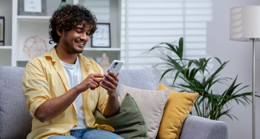 Resident navigating a home security app on his cell phone
